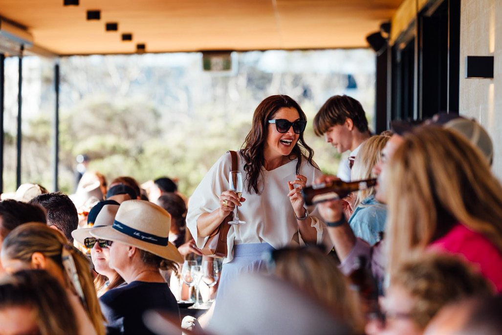 Guests laughing over lunch on the deck